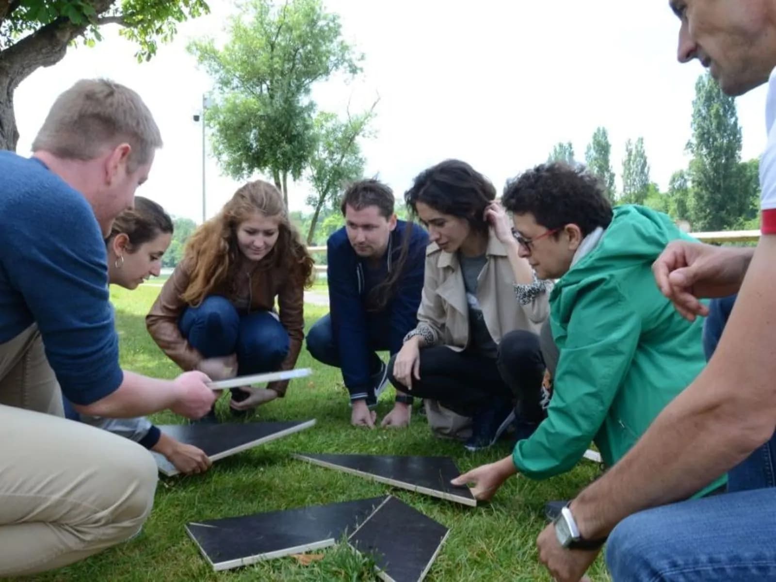 Participants playing a sports game outdoors during team olympics