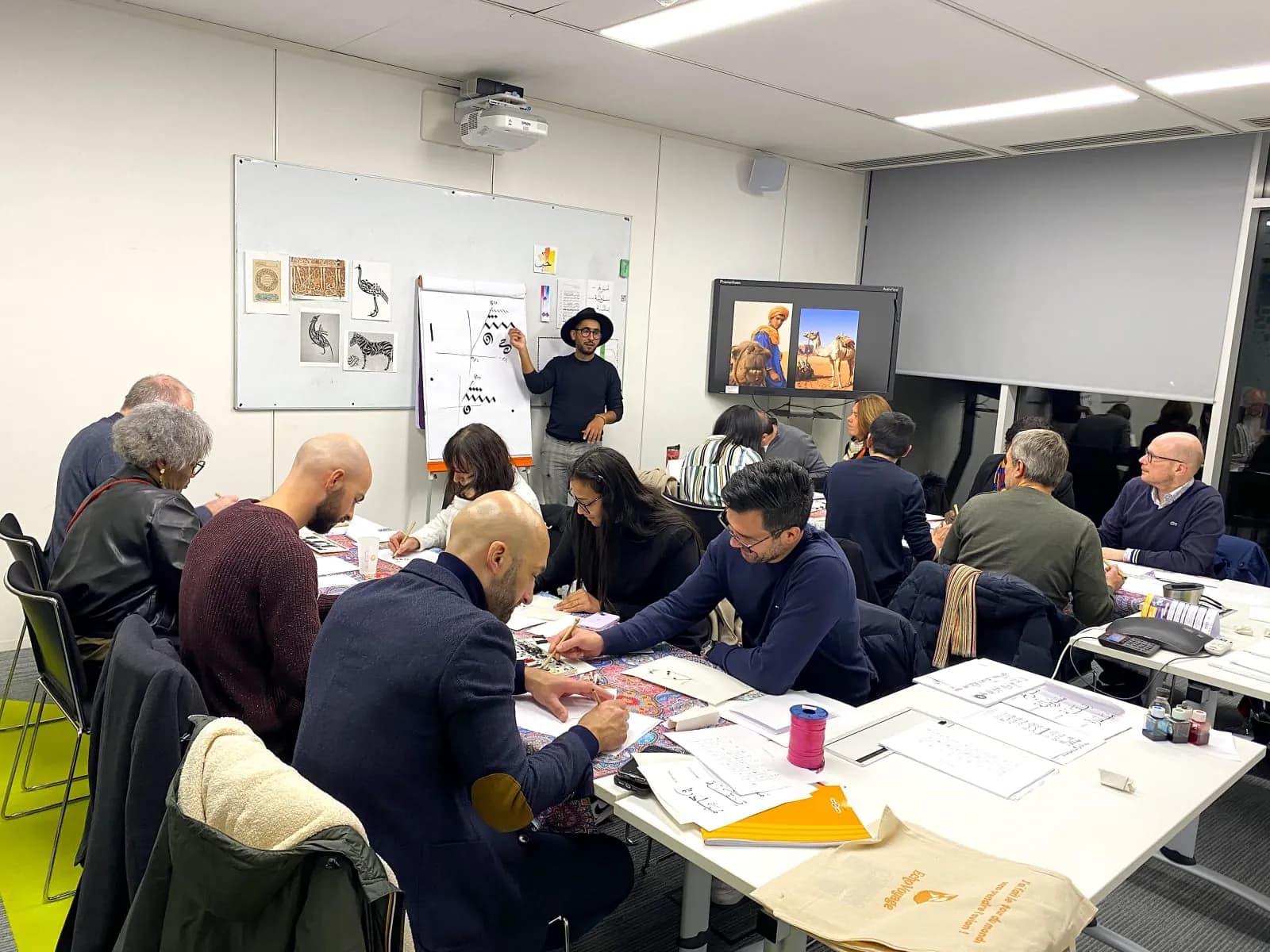Participants creating crafted objects during a cultural workshop in Paris