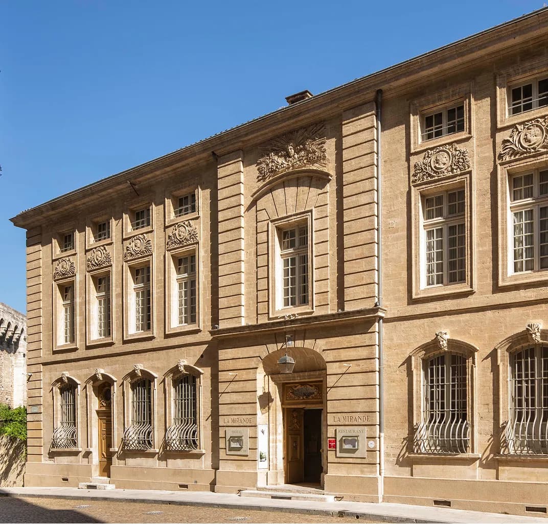 Stone façade of La Mirande, a historic townhouse hotel in the centre of Avignon, Provence