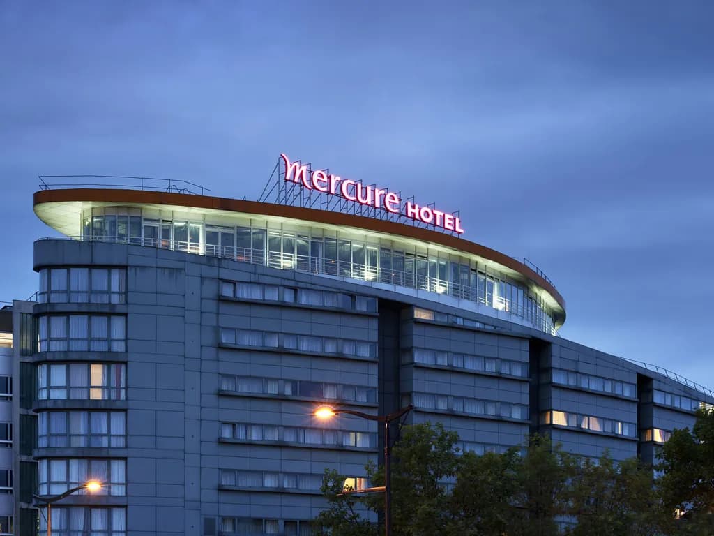 Exterior of Hotel Mercure Paris 19 Philharmonie La Villette at dusk, a seminar hotel in Paris 19e