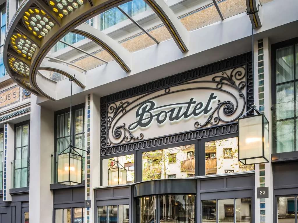 Entrance of Boutet Bastille Hotel Paris on rue Faidherbe in the 11th arrondissement, under a glass canopy