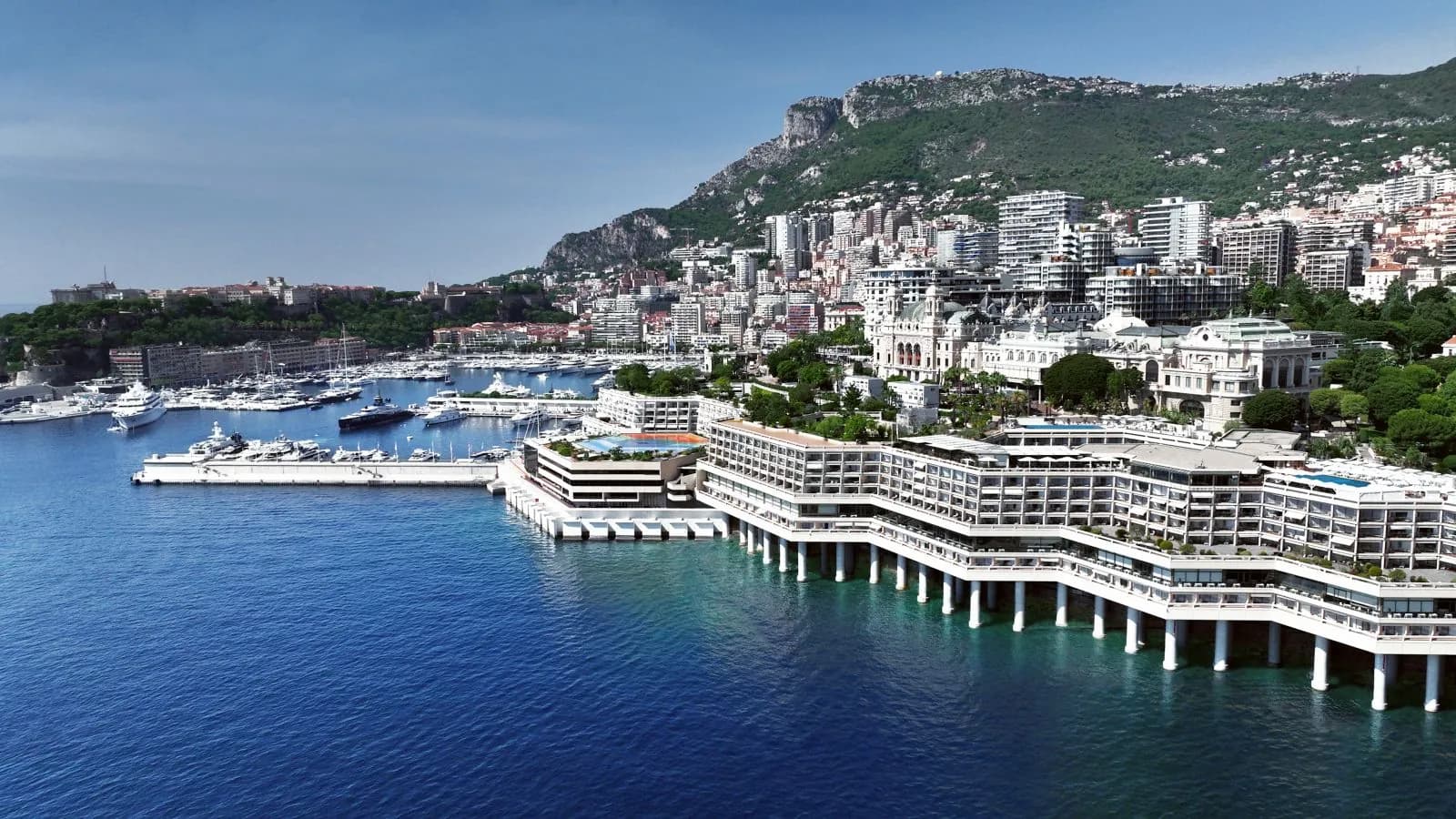 Aerial view of the Fairmont Monte Carlo on the waterfront of Monte-Carlo harbour, with the Rock behind