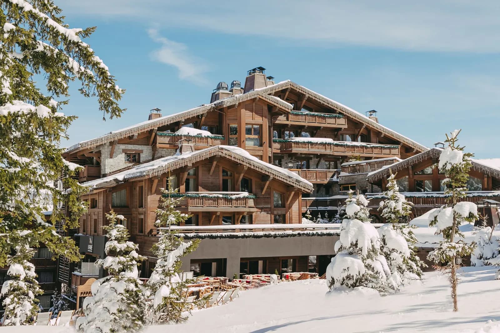 Exterior of Hôtel Fouquet's Courchevel, a snow-covered timber and stone chalet in Courchevel 1850