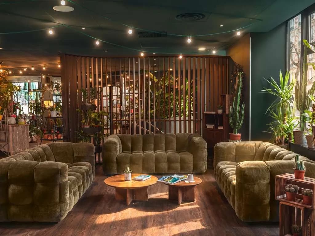 Lobby of ibis Paris Bastille Opéra in the 11th arrondissement, with green sofas and plants