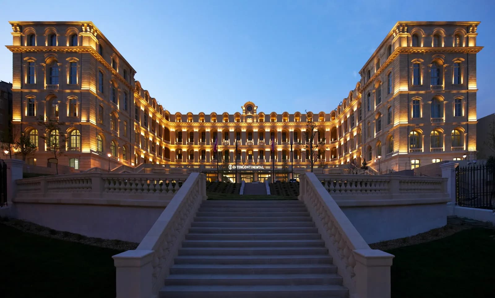 InterContinental Marseille - Hôtel Dieu facade and grand stairway at dusk, Marseille