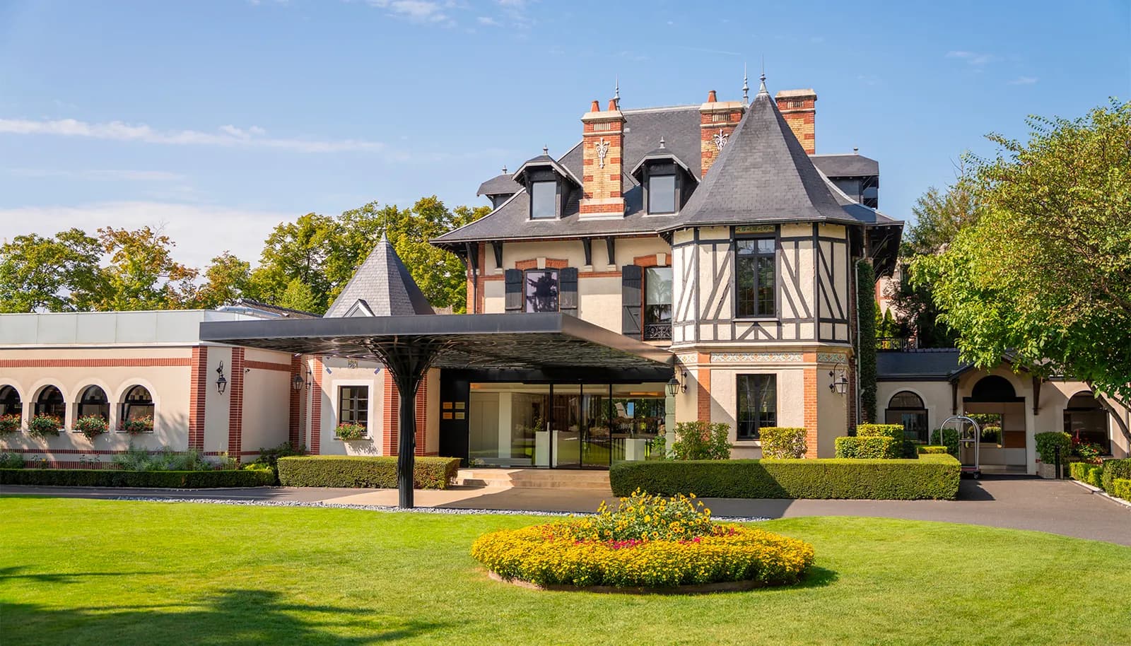 Exterior of L'Assiette Champenoise, a half-timbered château-style hotel and restaurant in Tinqueux, Reims