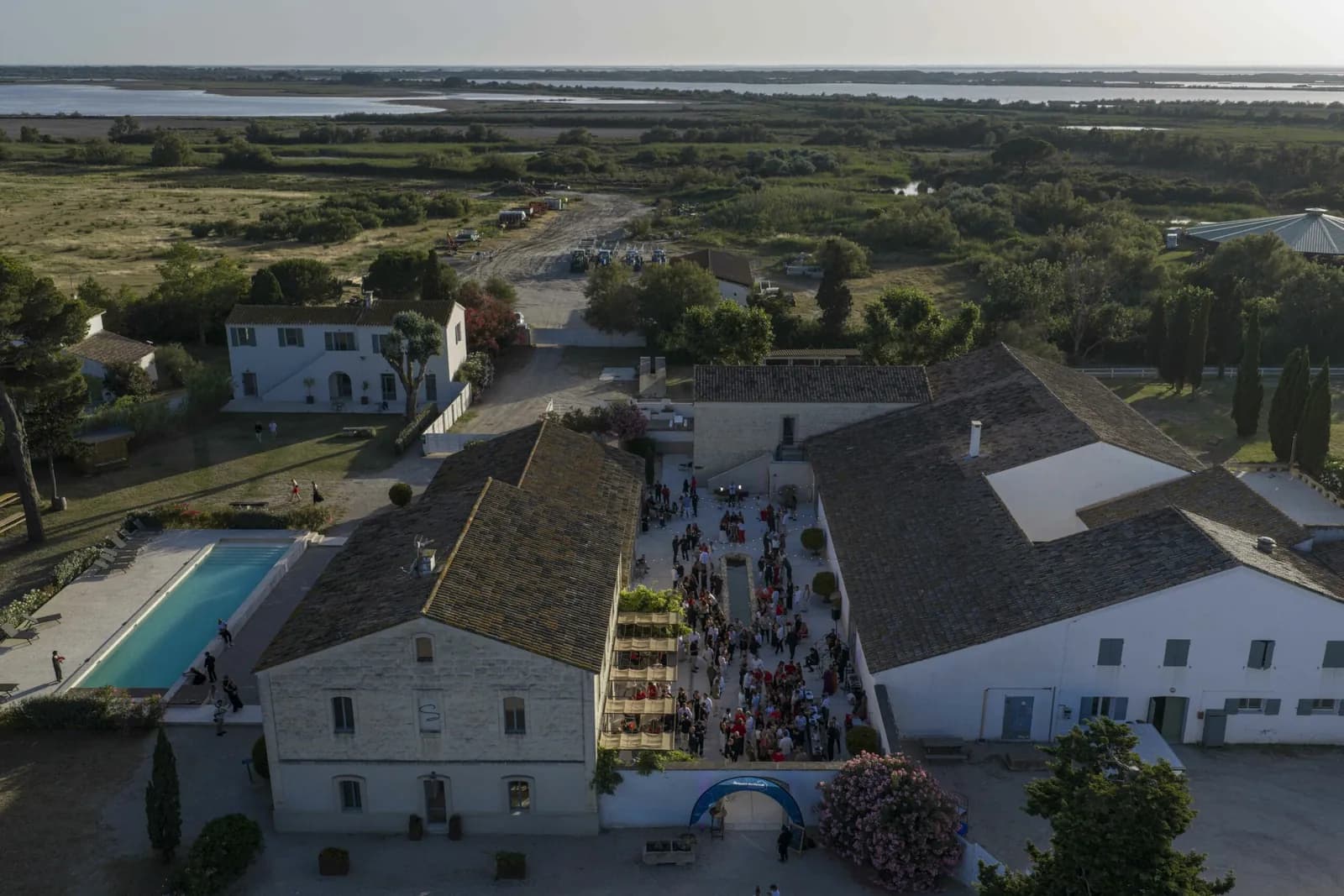 Aerial view of the Domaine Le Sauvage farm buildings and courtyard among the Camargue wetlands