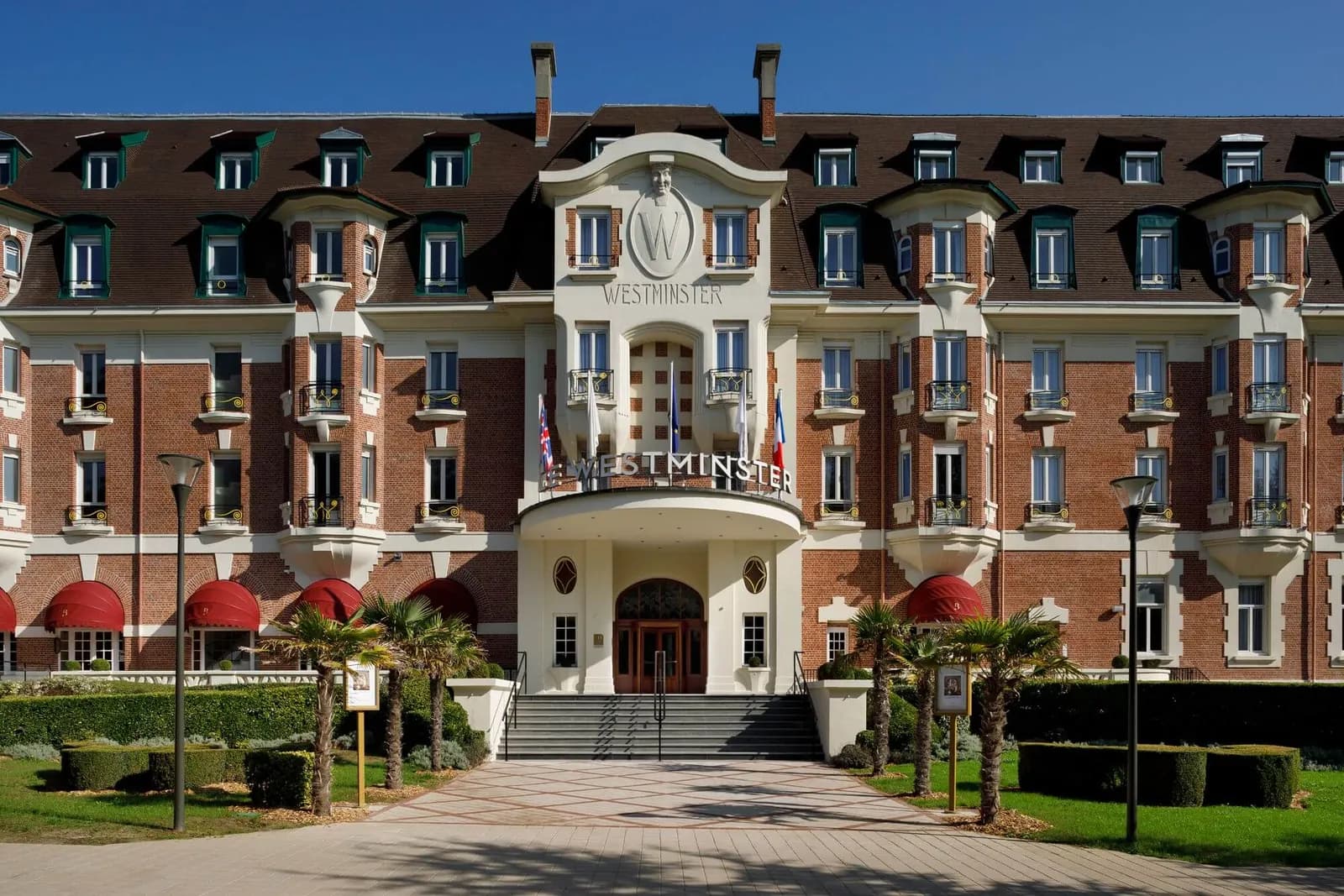 Facade of Hôtel Barrière Le Westminster with its red-roofed entrance, Le Touquet-Paris-Plage