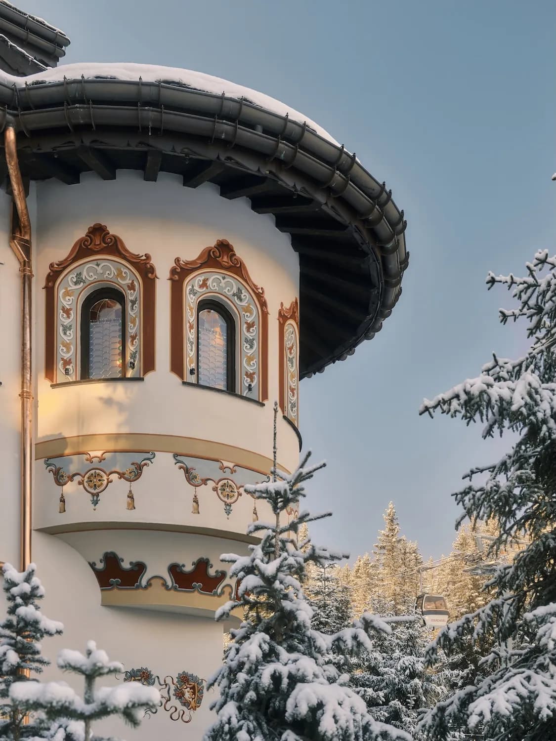 Snow-covered wooden turret with ornate windows at Les Airelles Courchevel, Courchevel 1850