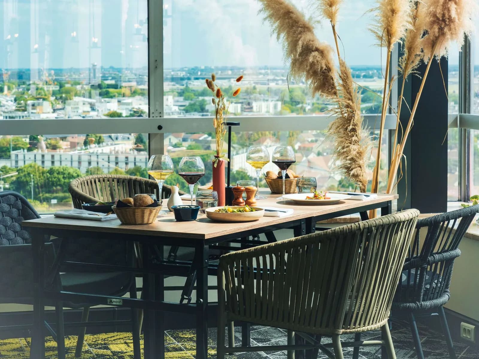 Restaurant at Mercure Paris Orly Rungis Airport with laid tables and tall windows over the surrounding area