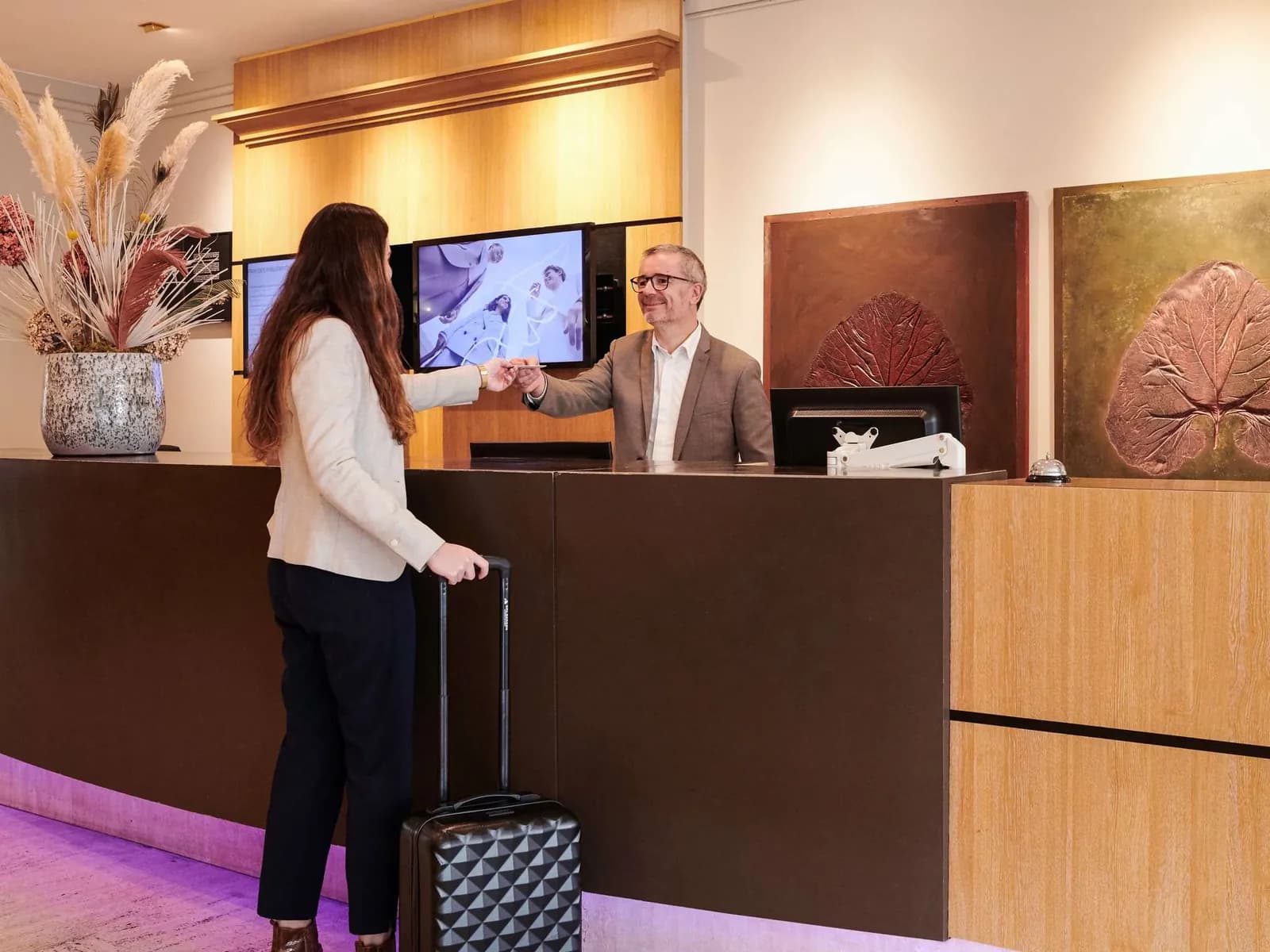 Guests checking in at the reception desk of Mercure Rennes Centre Gare hotel, Rennes