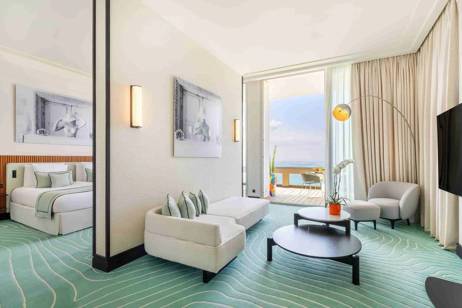 Sea-view guest room with pale furnishings and terrace doors at Mondrian Cannes on the Croisette