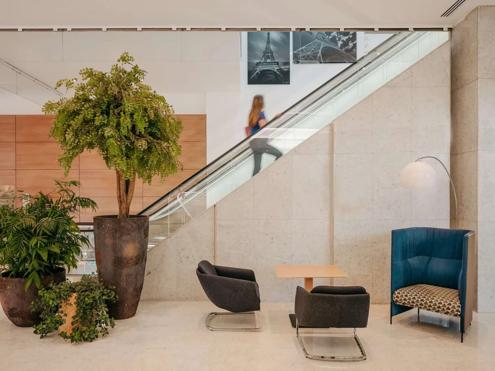 Lounge with a tall indoor staircase and armchairs at Novotel Paris Centre Tour Eiffel
