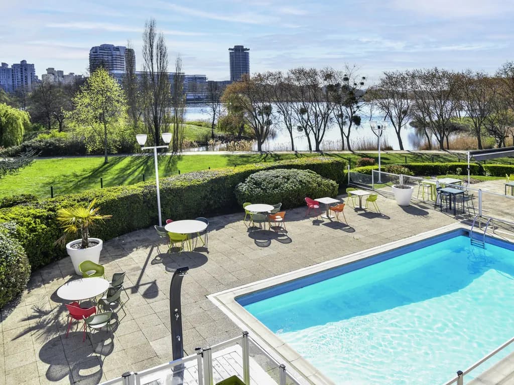 Terrace pool and lawn beside the lake at Novotel Paris Créteil Le Lac, near Paris