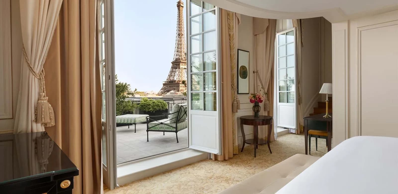 Guest room with open balcony doors framing the Eiffel Tower at Shangri-La Paris