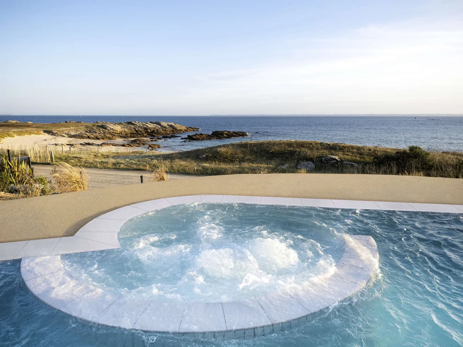 Outdoor jacuzzi on the terrace above the rocky Quiberon coastline at Sofitel Quiberon Thalassa sea & spa