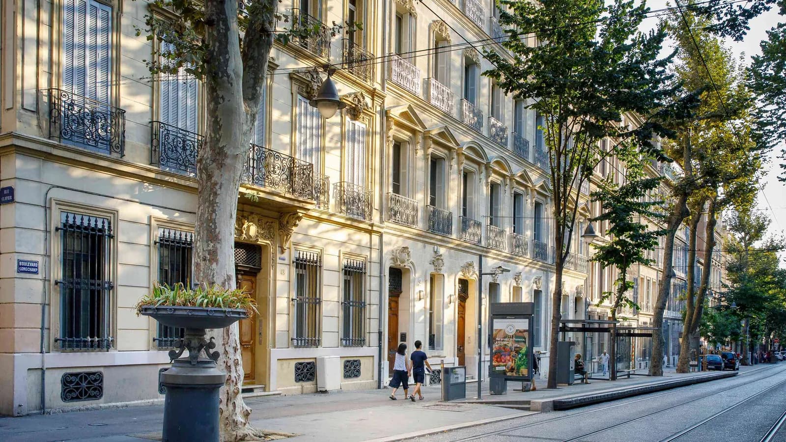 Stone facade and tree-lined street in Marseille, where Villa des Verrières stands