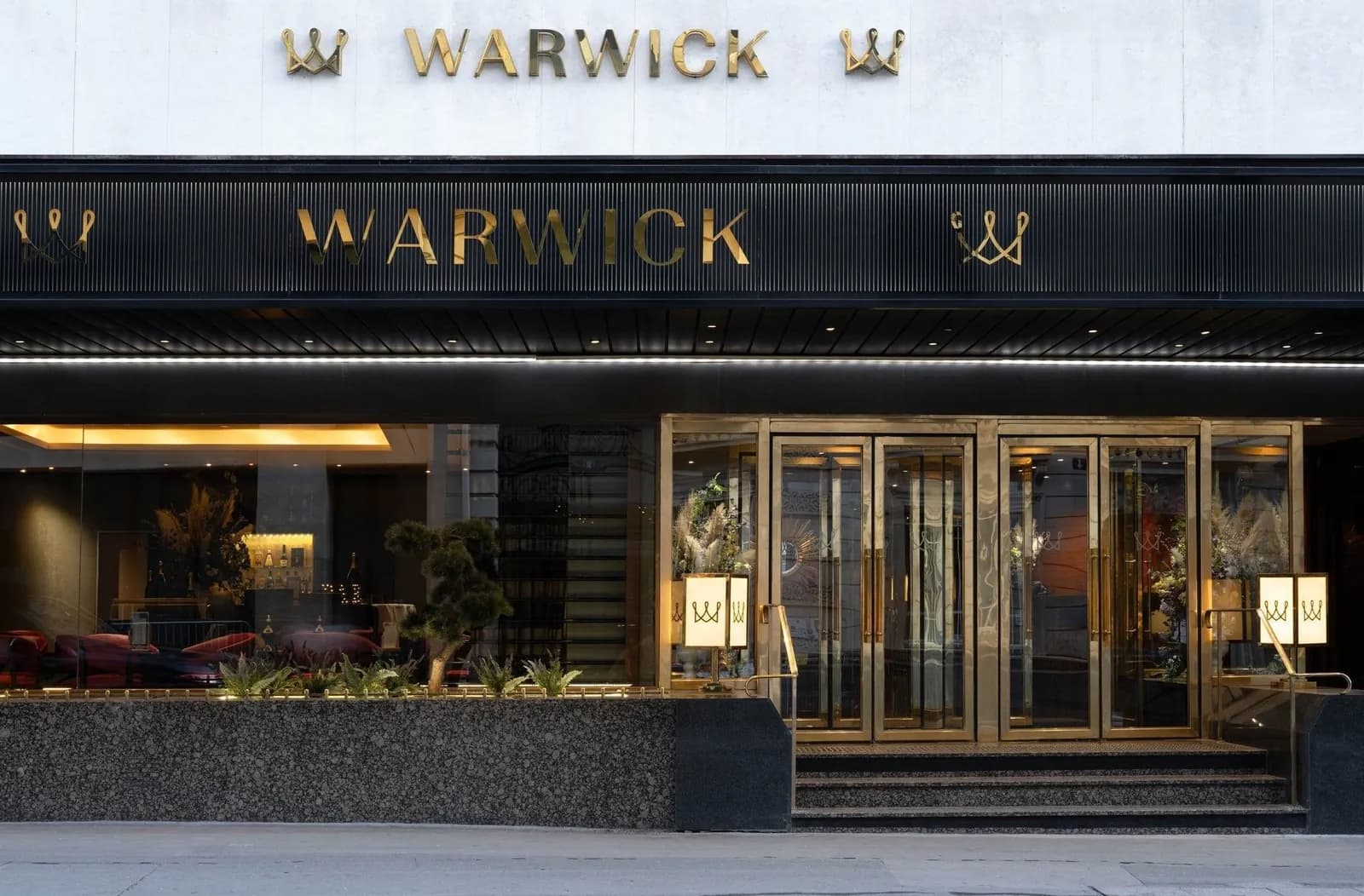 Entrance of Warwick Paris Champs-Élysées with its gold Warwick lettering and glazed revolving doors