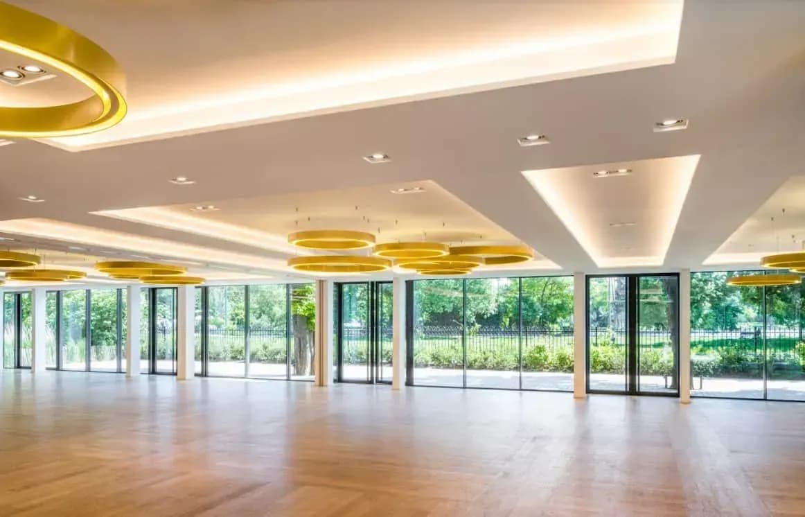 Ballroom with gilded chandeliers and a black and white chequered floor
