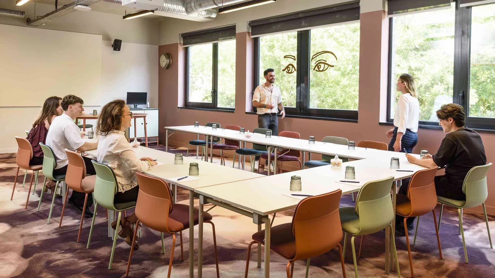 North Belvedere meeting room with red chairs around a long table under a glazed roof