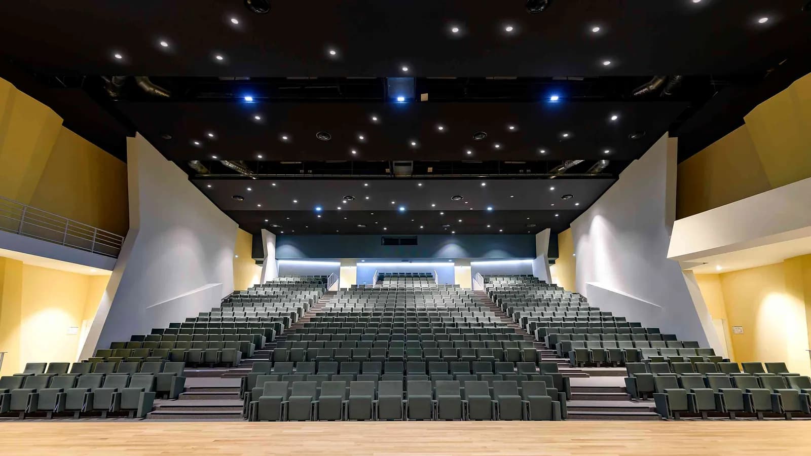 Horizon Forum auditorium with tiered seating, a wide stage and starry ceiling lights