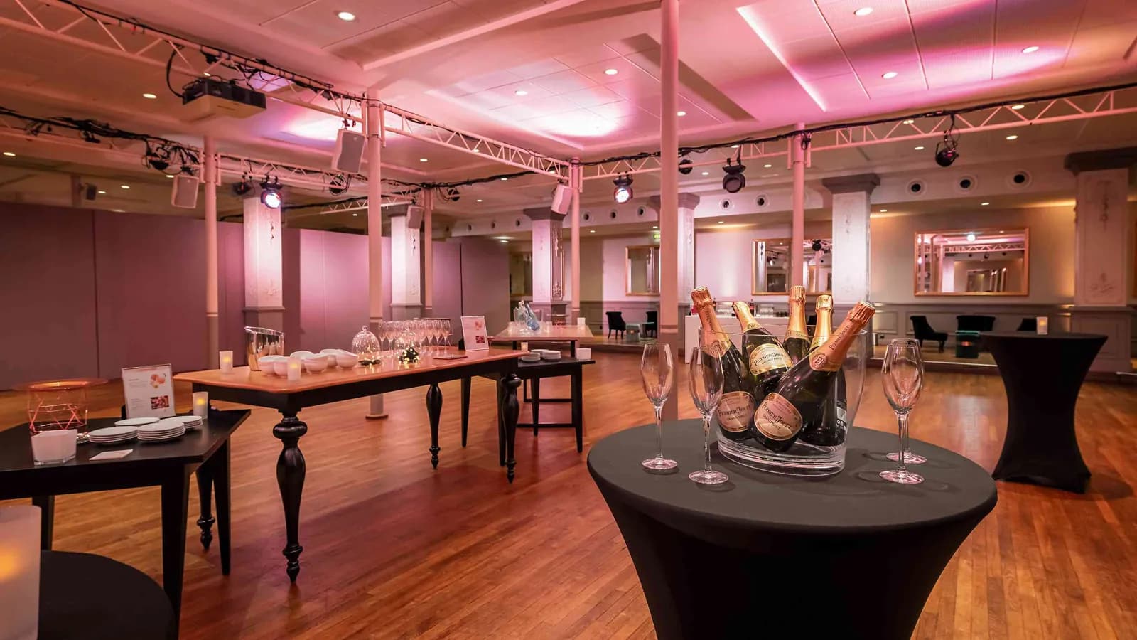 Étoile Grand Hall cocktail set-up with high tables, champagne bottles and pink lighting