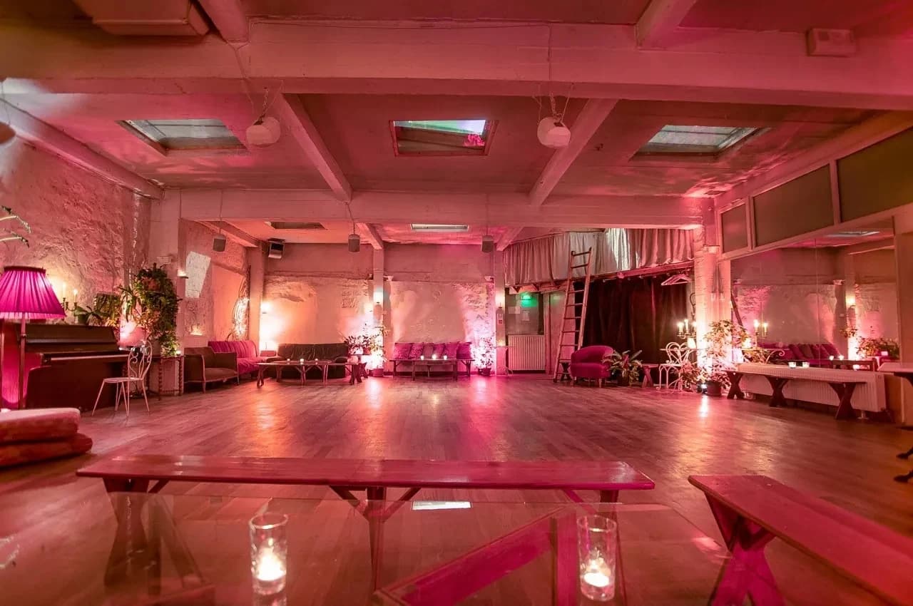 Loft lounge with pink lights, plants and a wooden floor