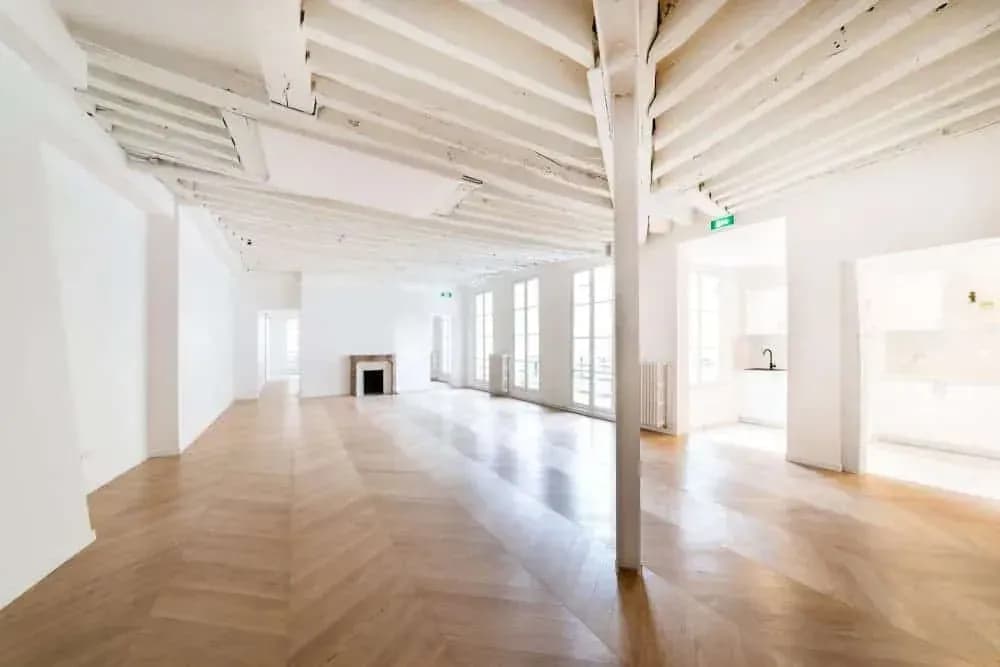 Open-plan loft with exposed beams and hardwood floors