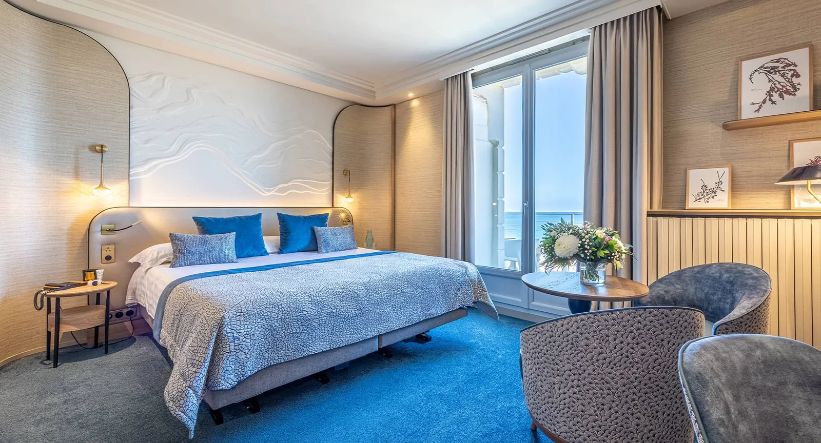 Guest room with blue accents and sea view at Le Grand Hôtel des Thermes, Saint-Malo