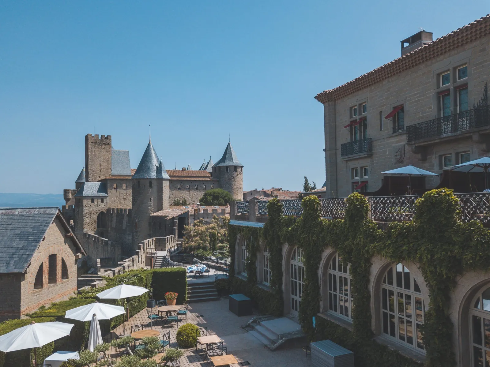 Terrace with parasols beside the medieval ramparts of Hôtel de la Cité, Carcassonne