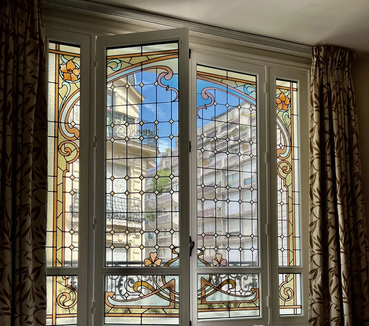 Art Nouveau stained-glass windows with floral patterns at Hôtel Vaneau Saint-Germain in Paris