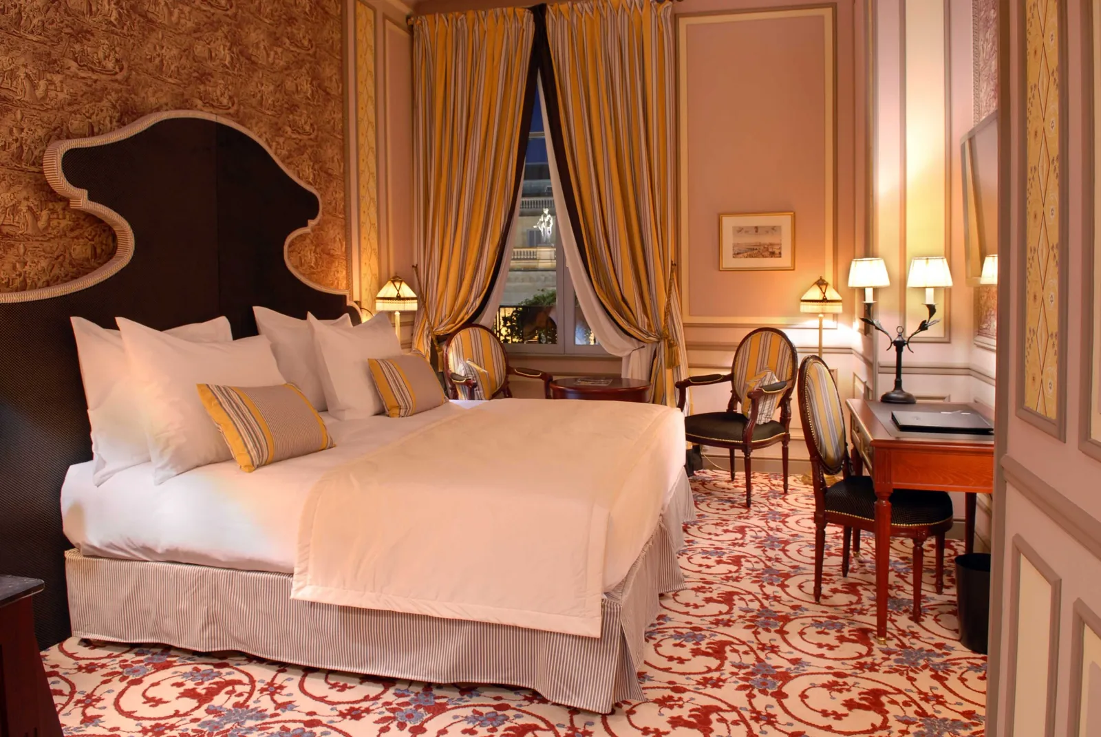 Guest room with a dark padded headboard and warm drapes at InterContinental Bordeaux Le Grand Hôtel