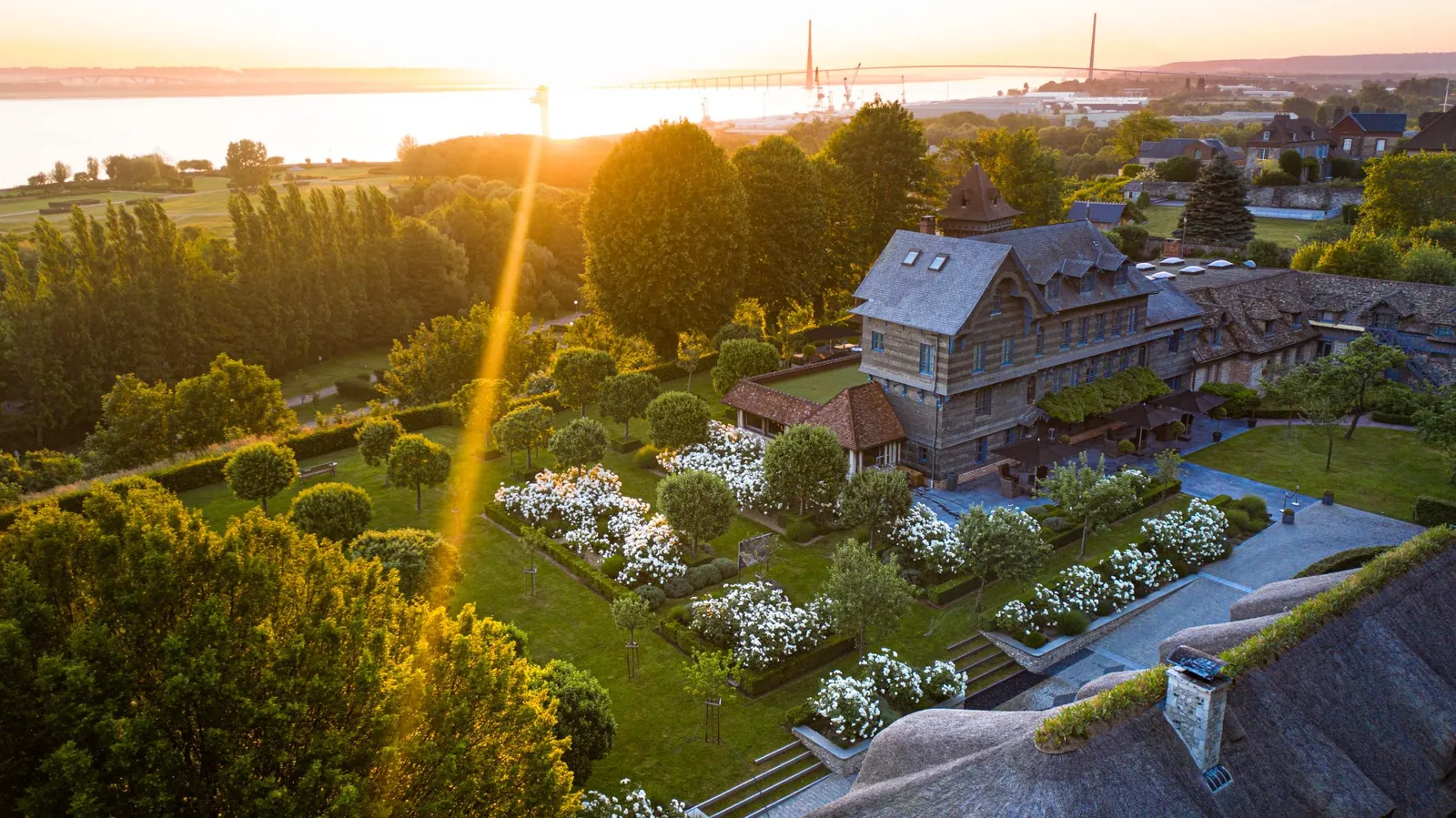Aerial view of the La Ferme Saint-Siméon estate and its gardens in the Honfleur countryside at sunset