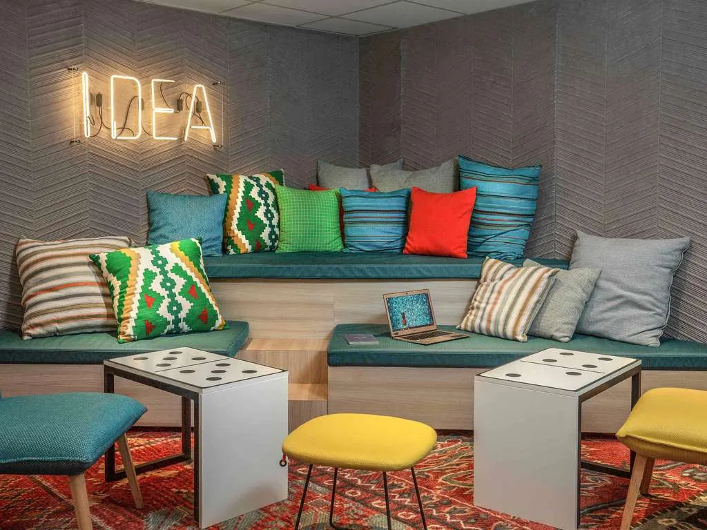Lounge with coloured cushions and a neon sign at Mercure Paris Centre Gare Montparnasse, Paris 14th