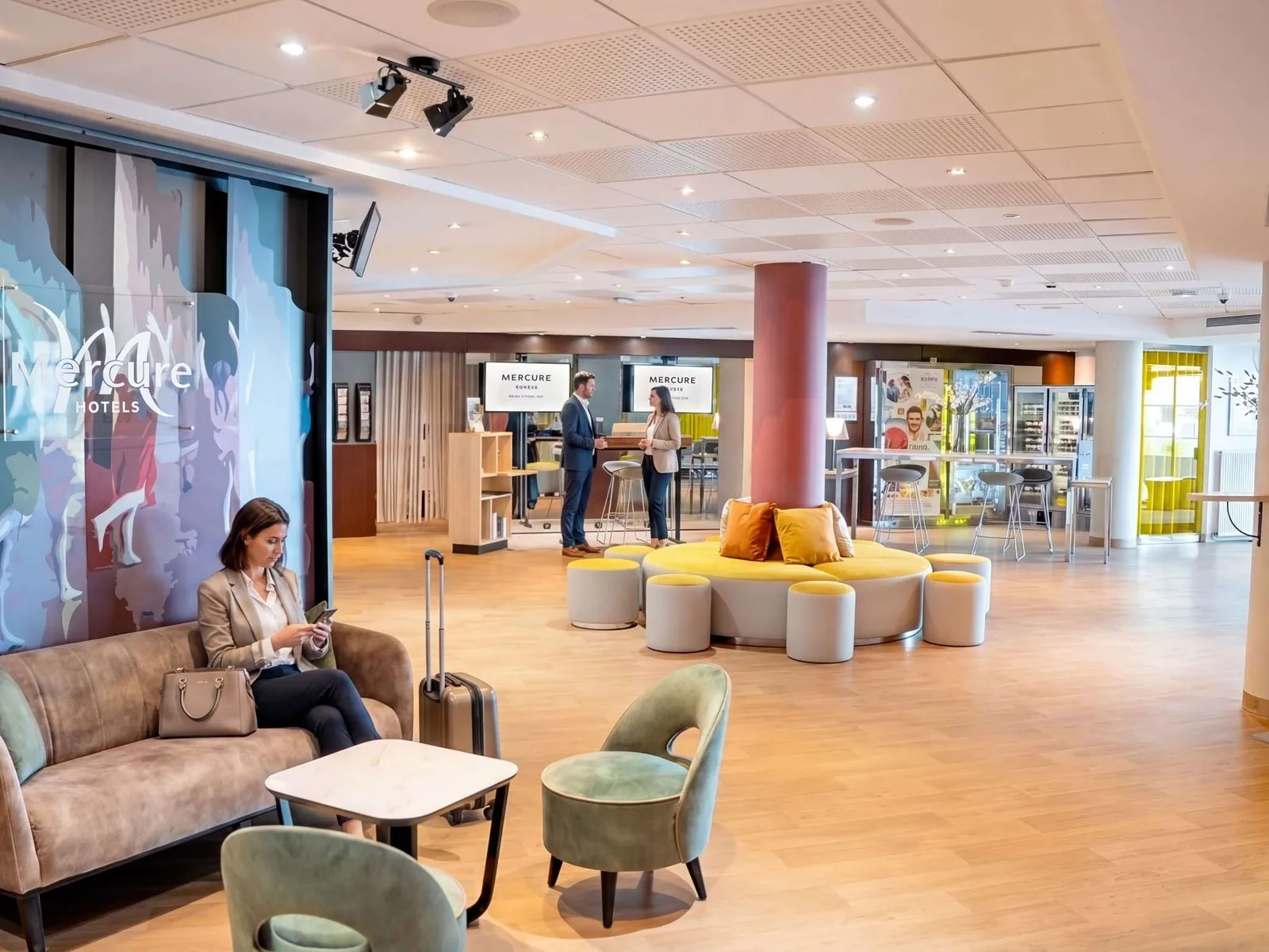 Lobby lounge with yellow armchairs and a round pillar at Mercure Paris Massy Gare TGV, Massy