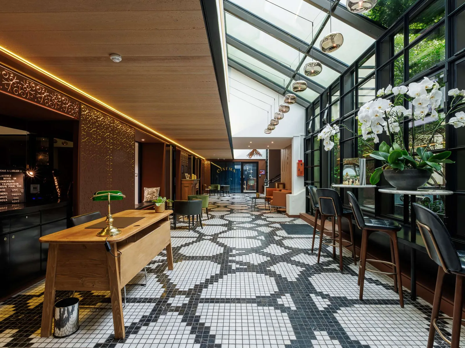 Lounge bar with a mosaic floor and a wooden bar counter at Novotel Paris Les Halles, Paris 1er
