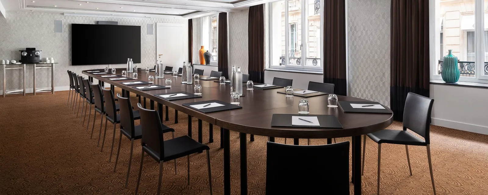 Boardroom at Prince de Galles, a Luxury Collection Hotel, Paris, with an oval table and wall screen