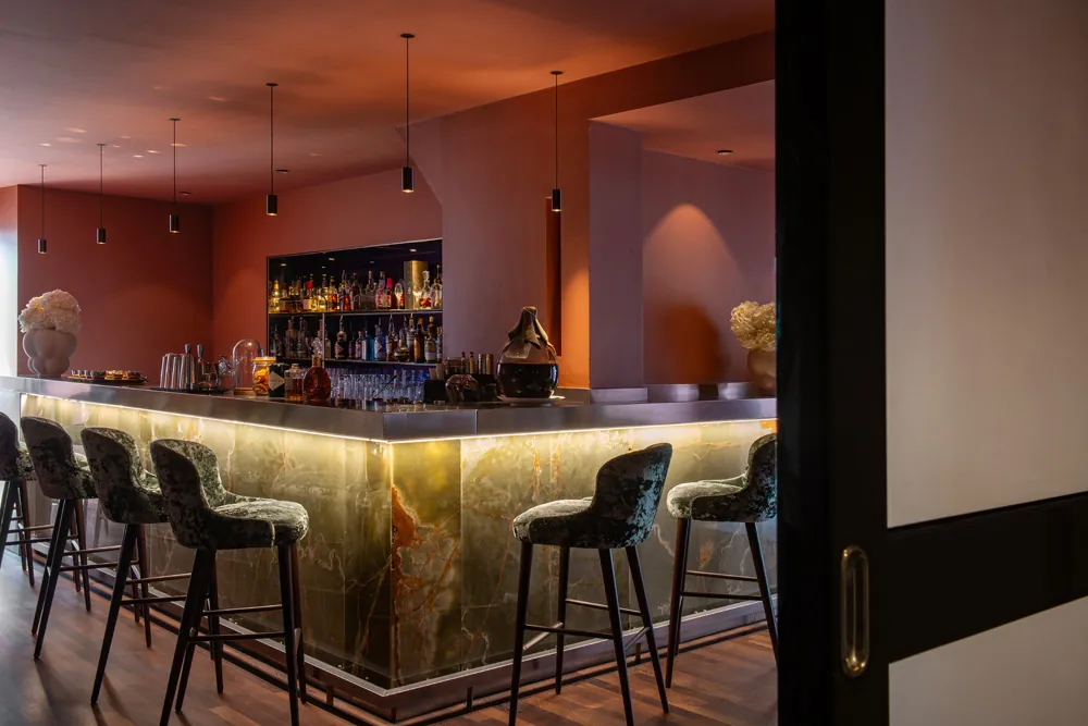 Bar with a marble-topped counter and backlit stools at Régent Petite France hotel, Strasbourg