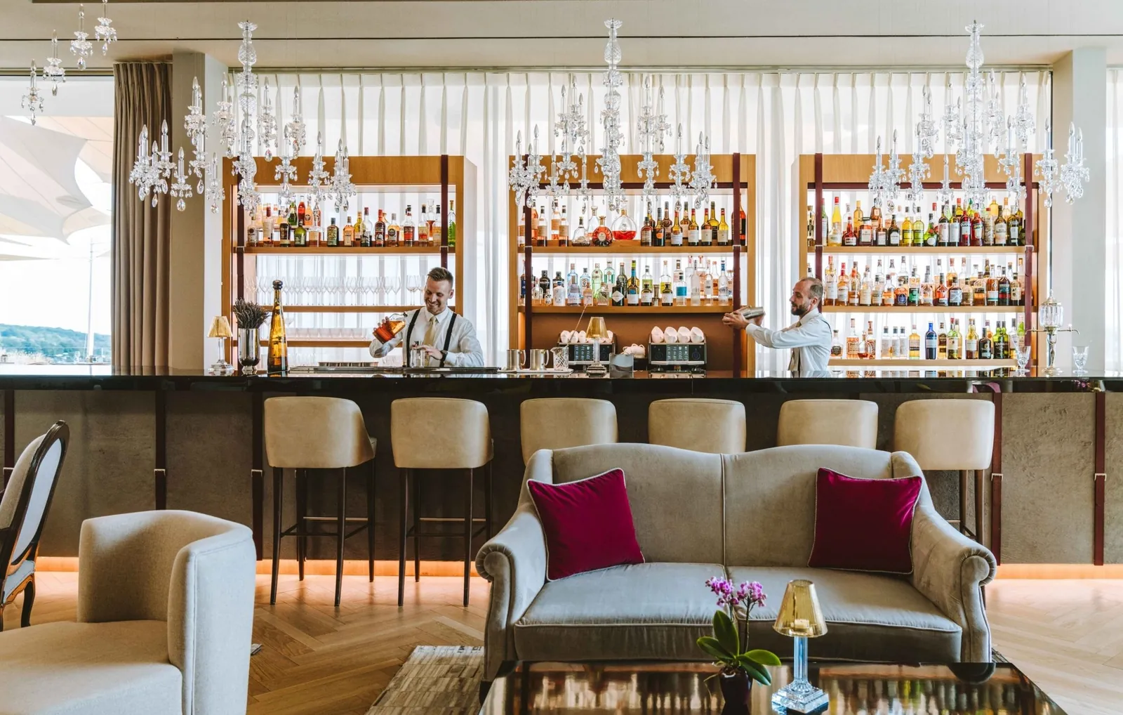 Bar with crystal chandeliers and bartender at Royal Champagne Hotel & Spa, Champillon