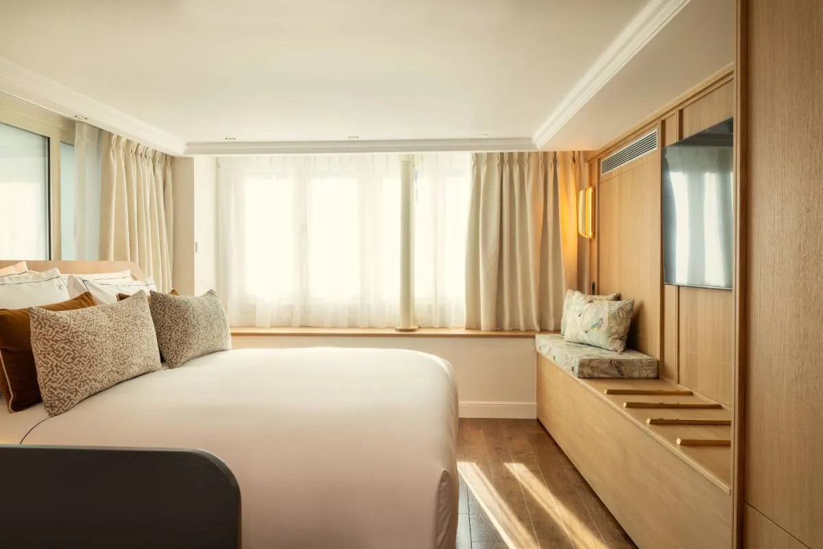 Guest room at Hôtel & Spa Royal Madeleine in Paris with a double bed and a window seat