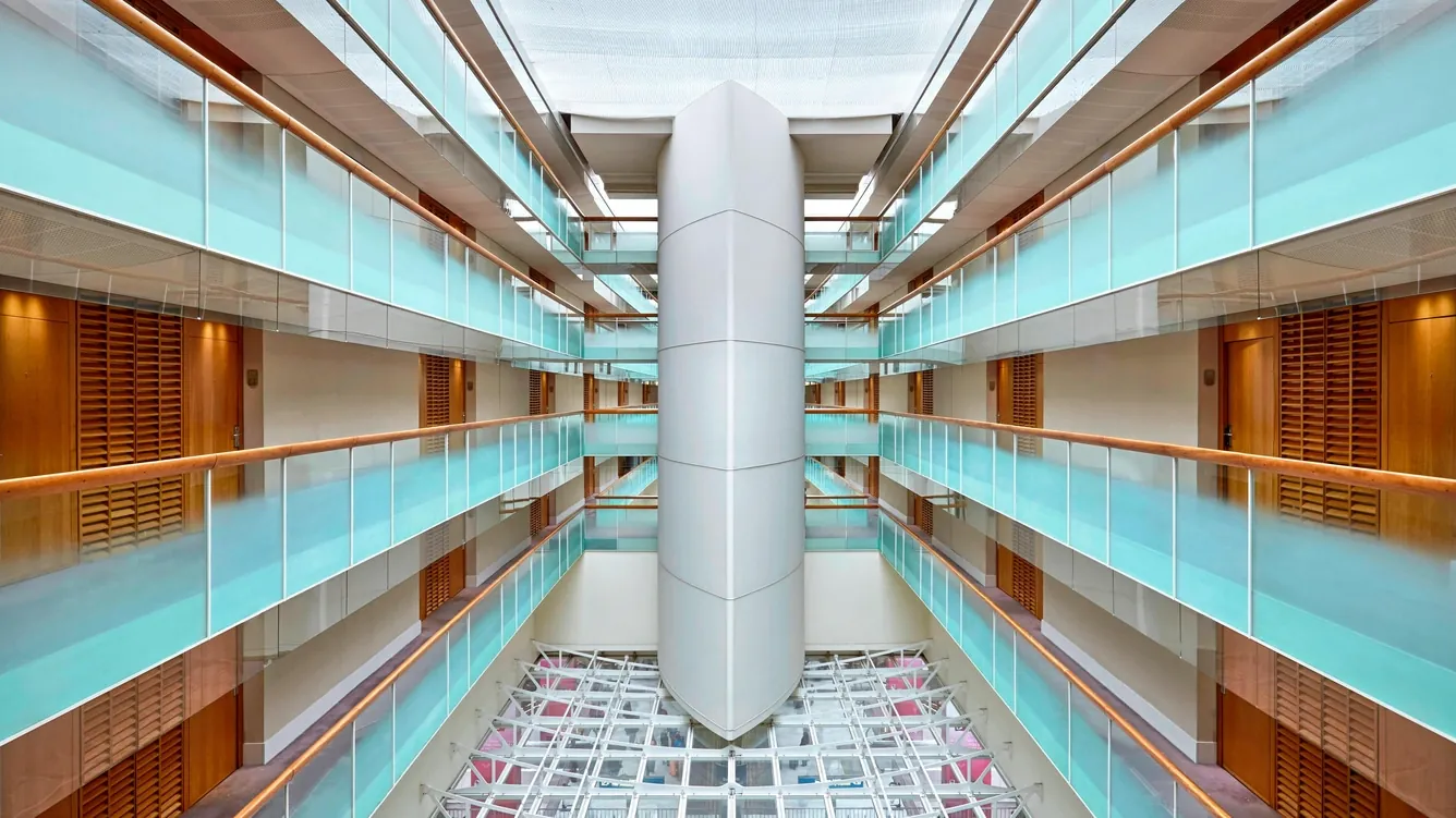 Central atrium of the Sheraton Paris Airport Hotel with glass-walled galleries and a white column