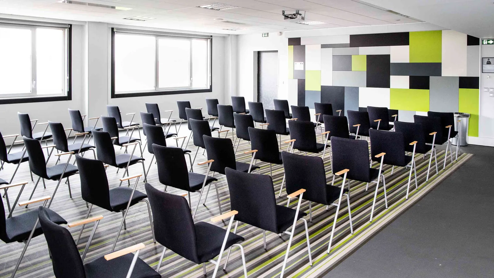 Northern Workshops training room with a graphic feature wall and rows of black chairs