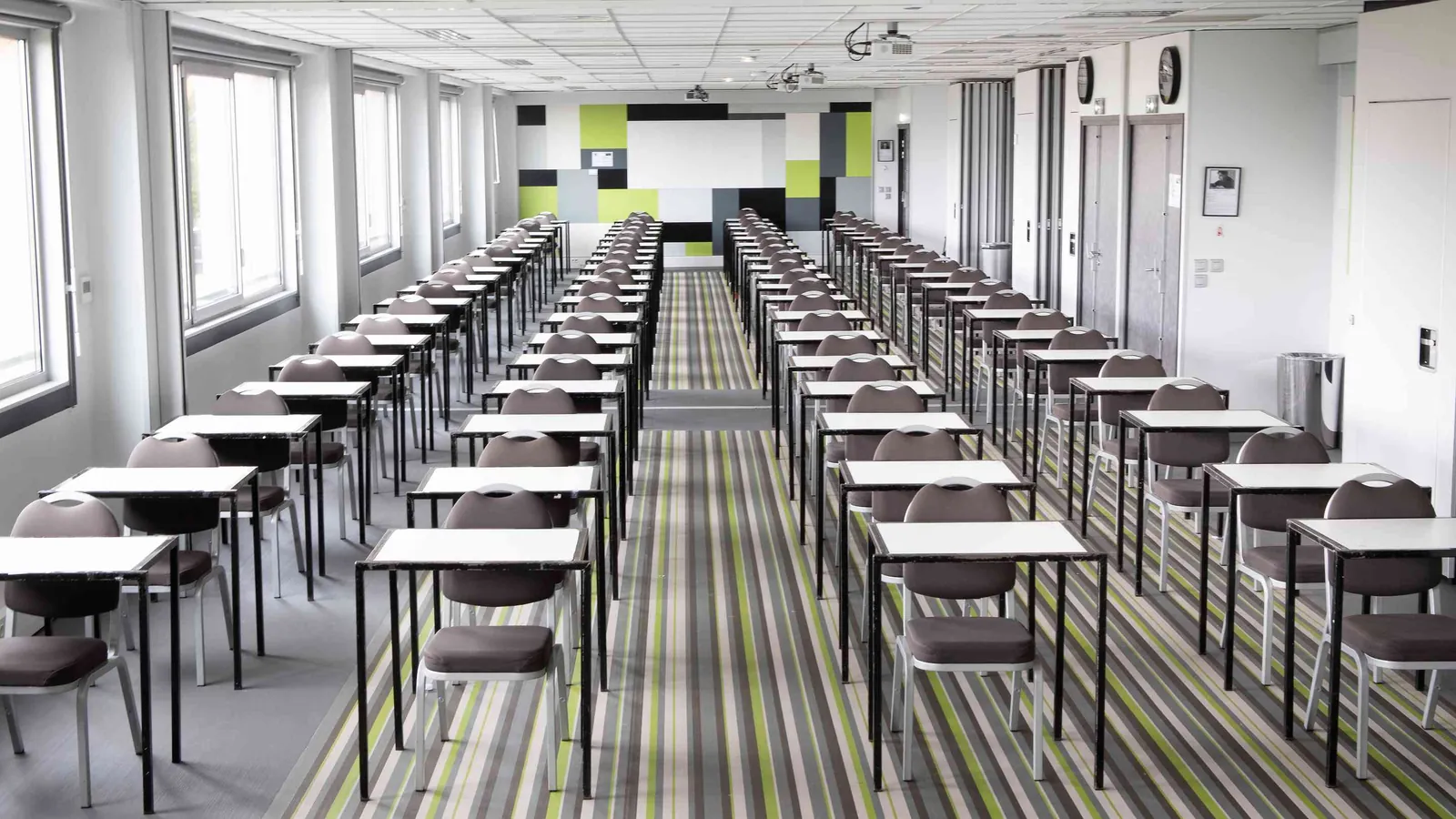 Northern Workshops seminar room set in classroom rows with desks and a wall of colour