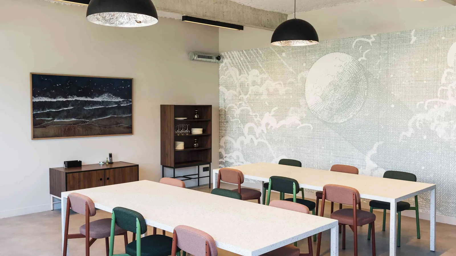 North Belvedere meeting room with a graphic wall, pastel chairs and a long table