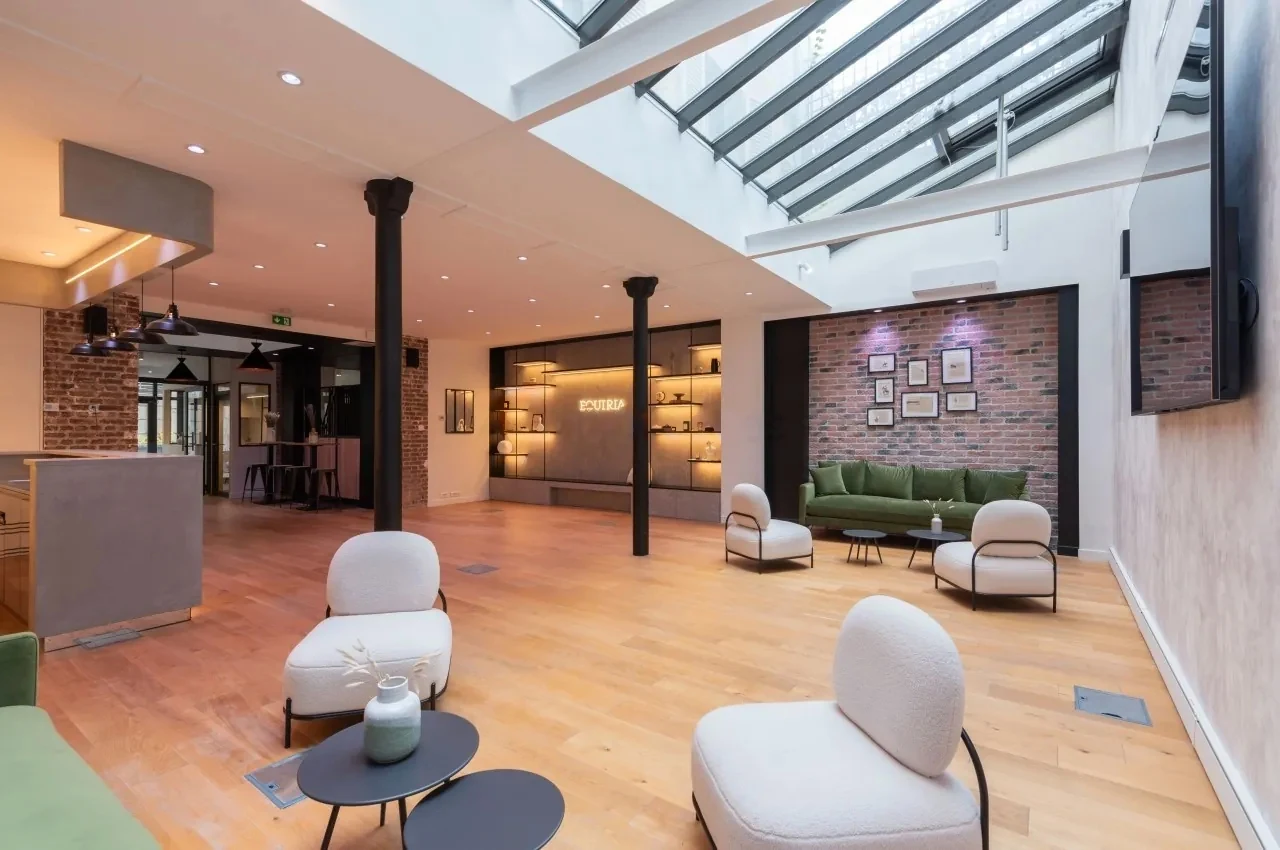 Lounge under a glass roof with armchairs and sofas