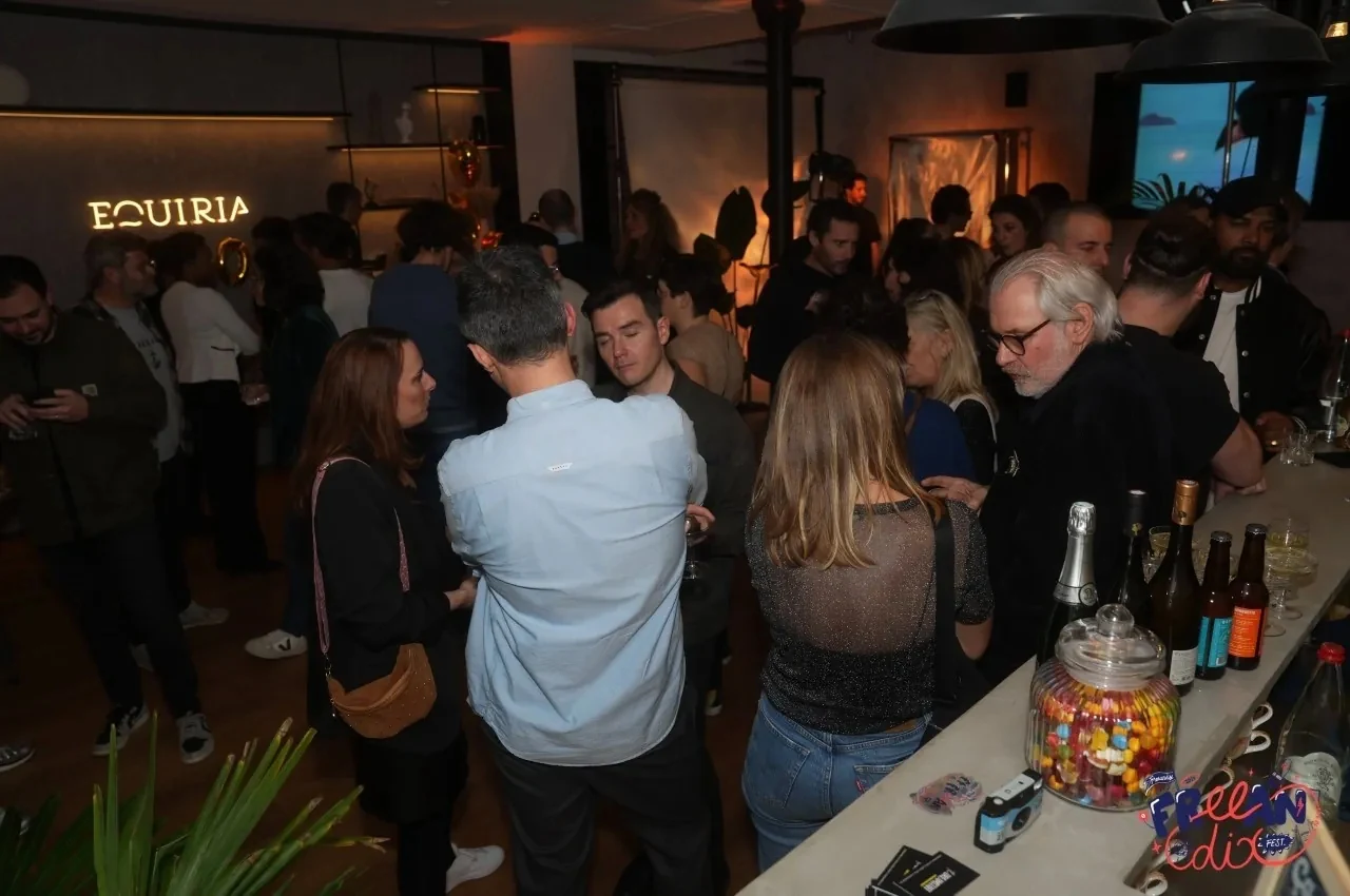 Evening reception with guests standing at the bar