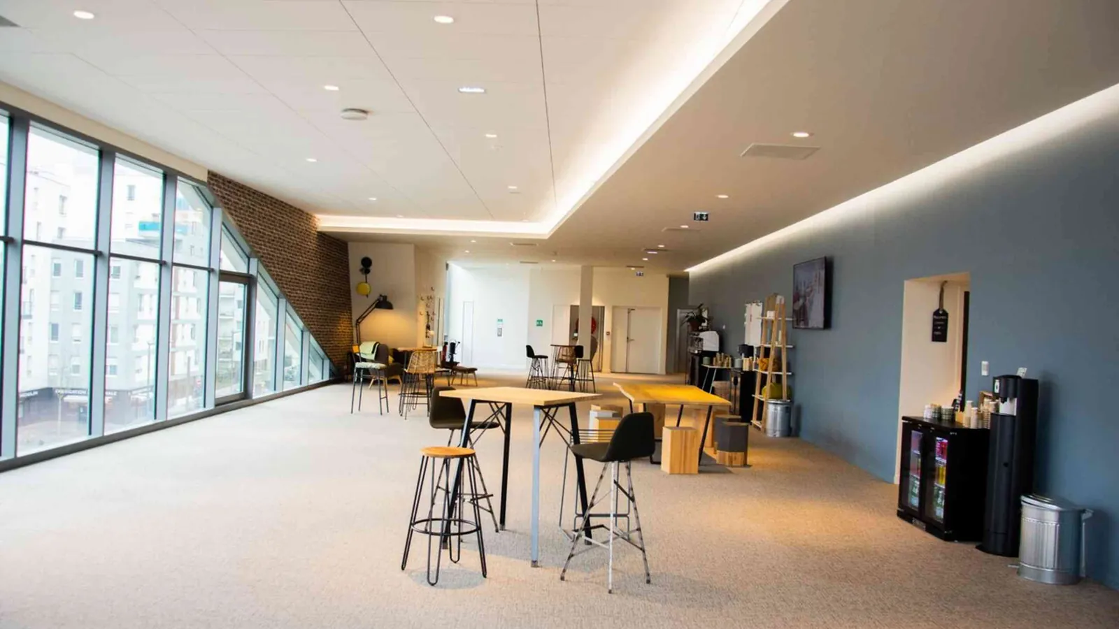 Horizon Forum open room with bar-height tables, stools and a wide bank of windows