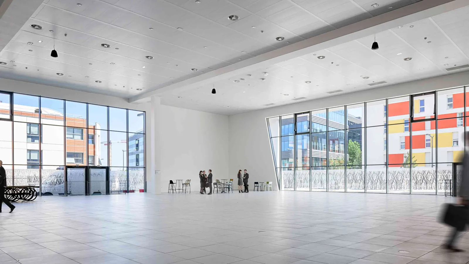 Horizon Forum bright open hall with light floors and full-height glazing onto the street