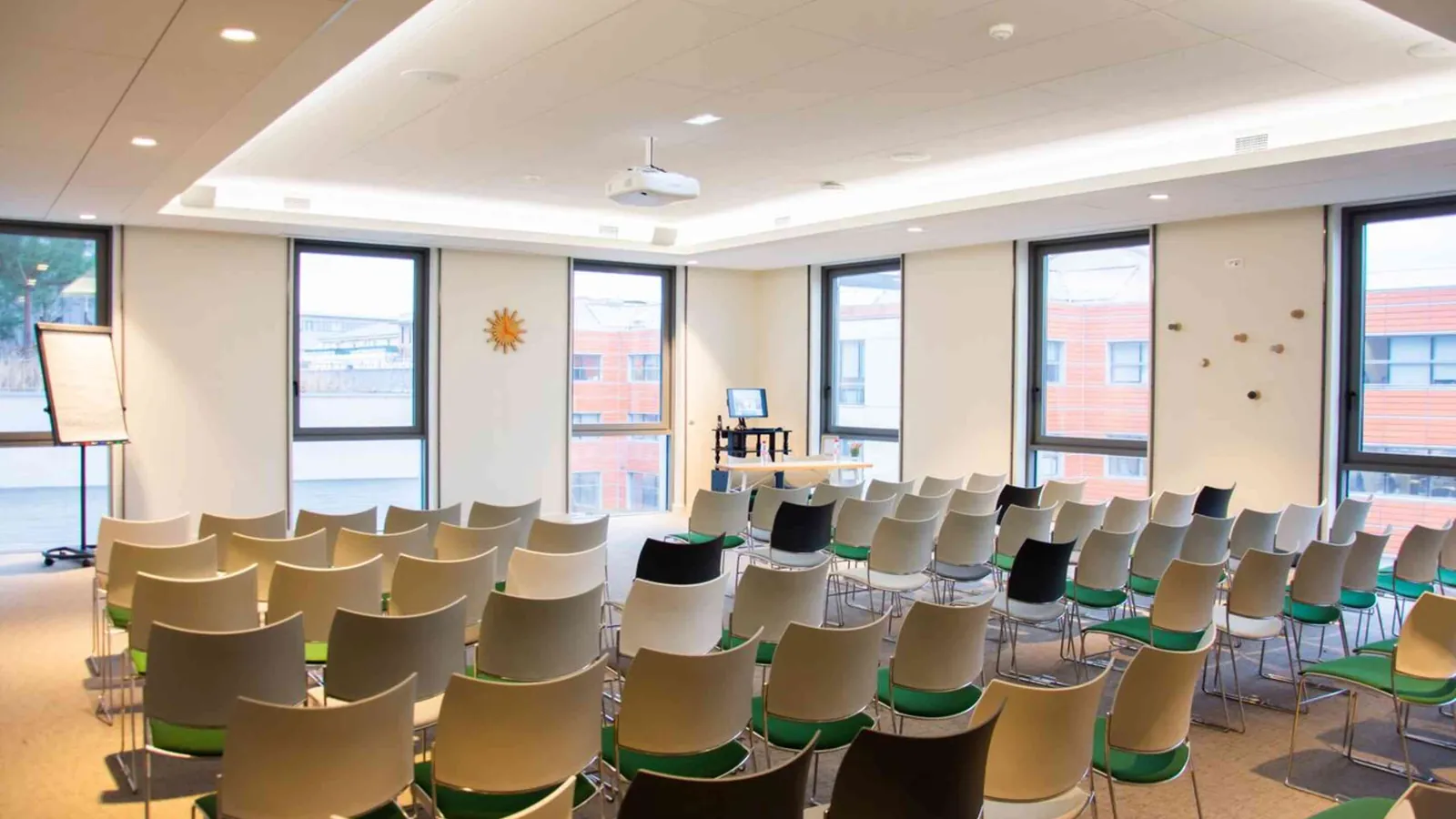 Horizon Forum training room with light wooden chairs in rows and a projection screen