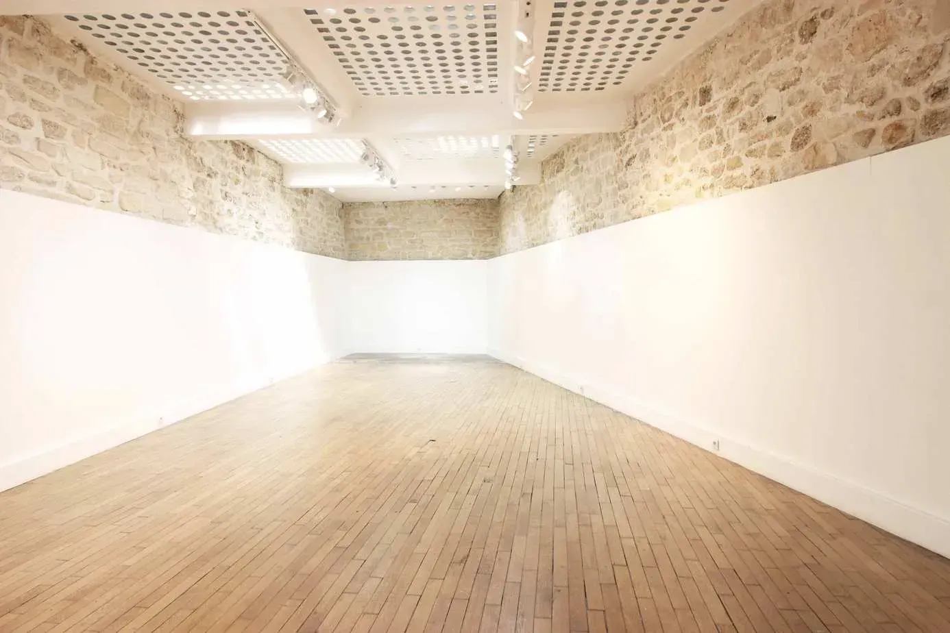 Room with a stone wall and a wooden floor